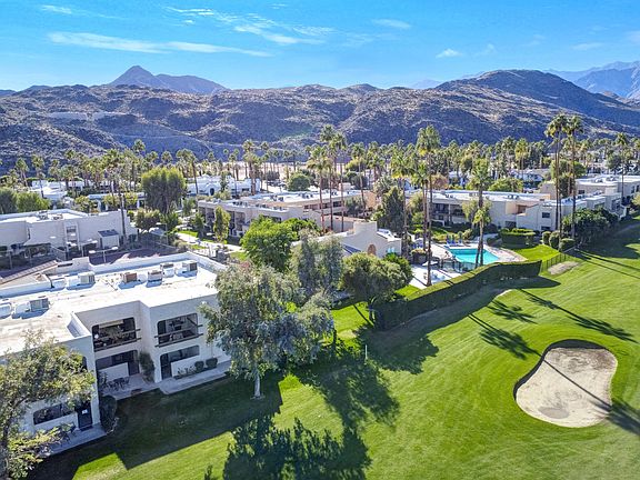 View of community and pool - condo is golf course adjacent with a view