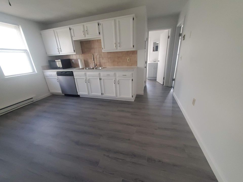 Large kitchen with new hard floor and a dishwasher and micro wave oven.