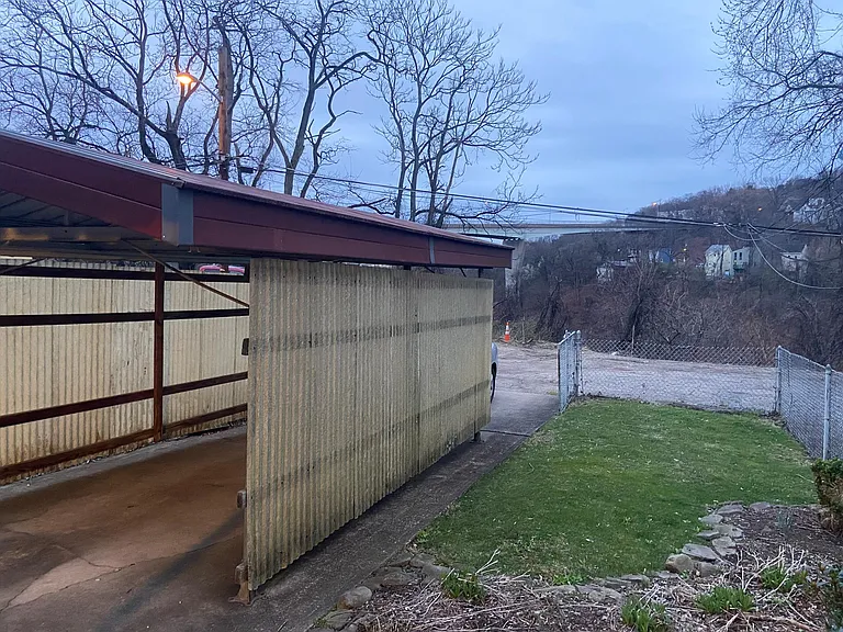 back yard, carport that can fit two cars