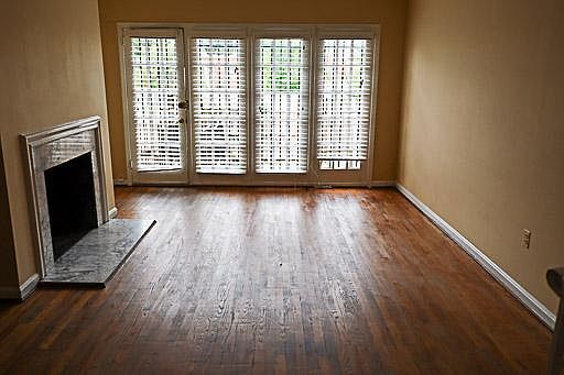 Main living room; open concept living and dining. View to back patio and parking