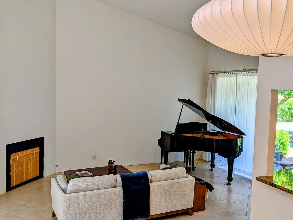 Living room with high ceilings and baby grand piano