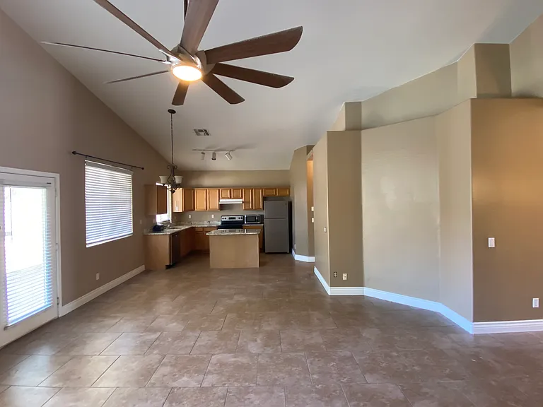 Great room with vaulted ceilings and large overhead fan.