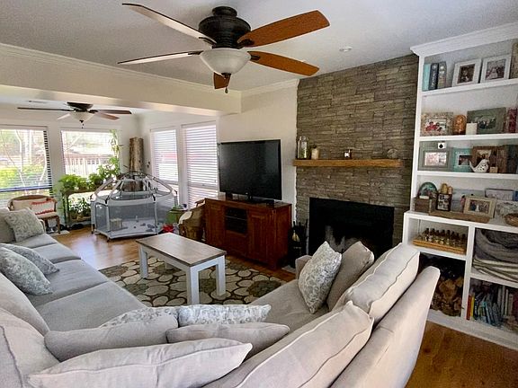 Living room with cozy, renovated stone fireplace and built-in for all the memories and gatherings to be had!