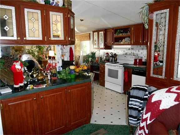 VIEW OF KITCHEN WITH GLASS AND WOOD CABINETS