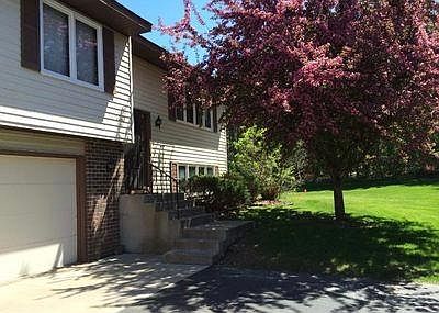 Front entrance. Large 2 car garage and off street parking for guests. Next to large green space with a beautiful flowering tree in the front yard.