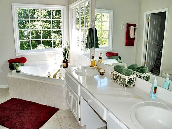 A jetted garden tub, a double vanity & a shower w/ bench seats speaks luxury.