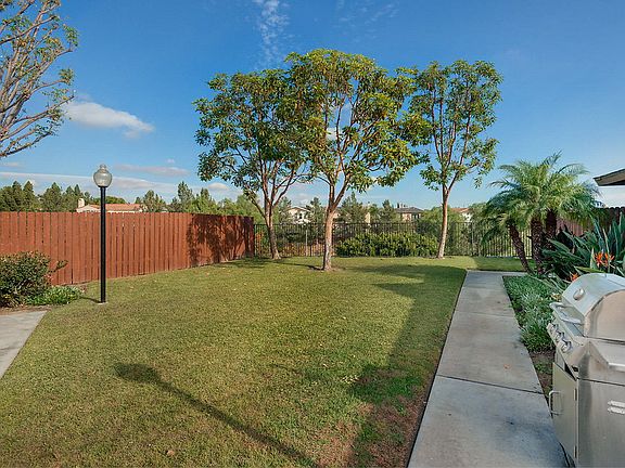 BBQ area with grass area and trees.