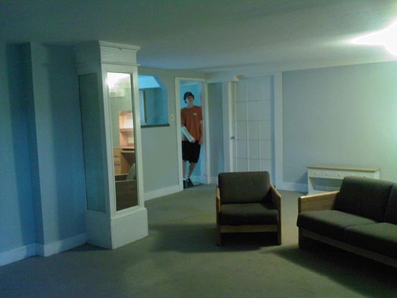 Living room with mirror column - my son standing in doorway to kitchen is 6'4"