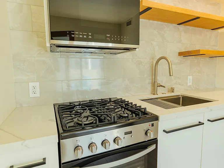 New stainless steel appliances with custom cabinetry. Includes stove, oven, microwave and dishwasher.