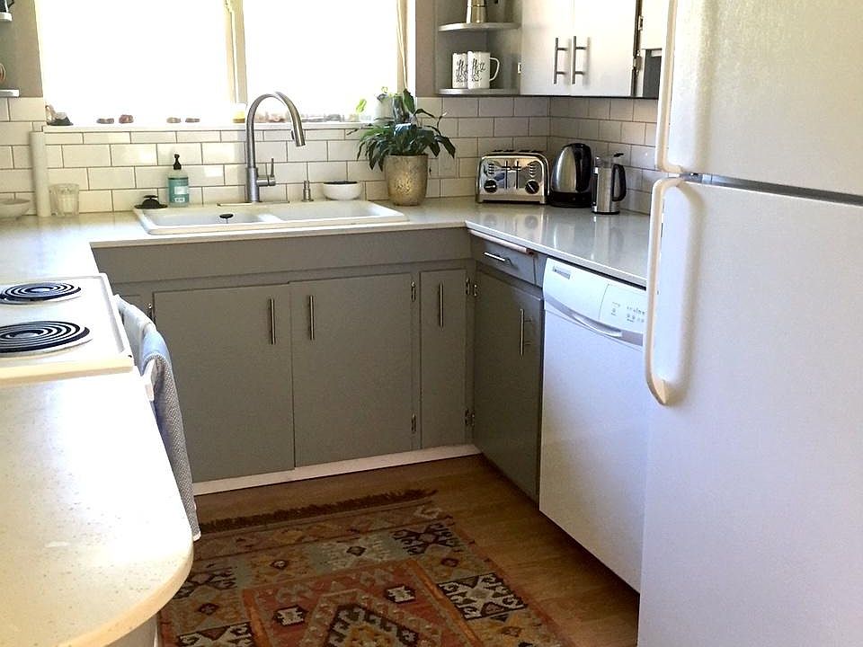 kitchen with quartz countertops, ample cabinets, upgraded dishwasher with stainless interior