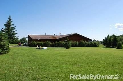 North side of house
						:
						Beautiful 1+ acres of manicured lawn in the front & back of house.