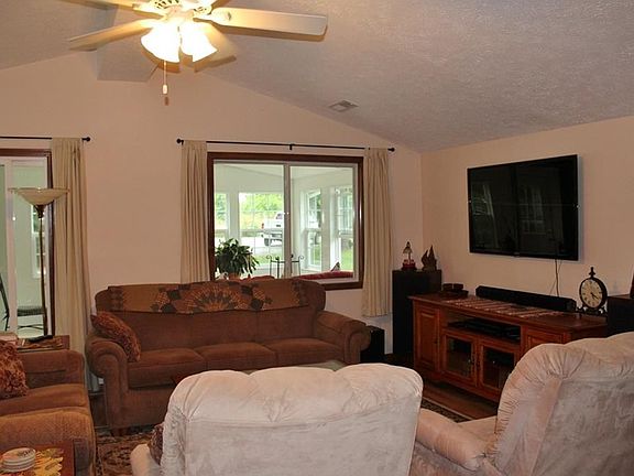 Great room with cathedral ceiling and ceiling fan with light.