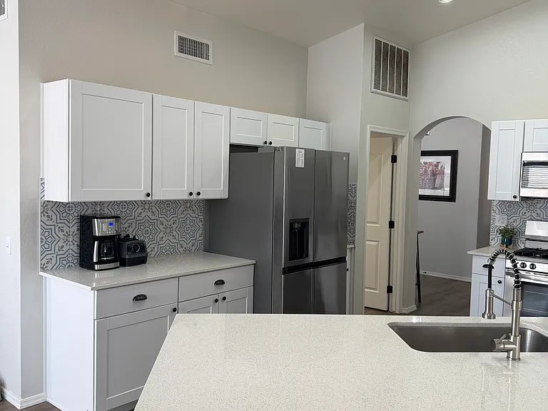 Kitchen viewed from bonus room. Door next to fridge leads to large laundry room and two car garage.