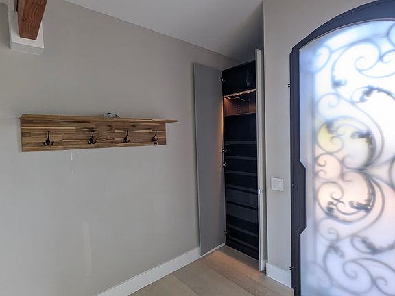 Entryway has a closet, shelf and rack.