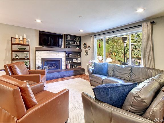 Bright large family room with large picture window, gas fireplace and built-ins. 