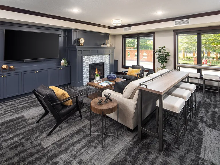 Clubhouse interior with lounger area and fireplace at The Whitley in St. Paul, MN.