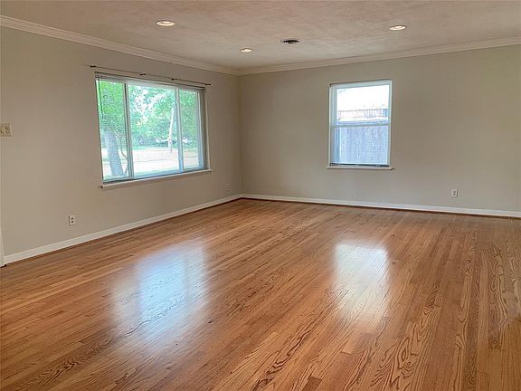 View of living room with lots of windows. Original hardwood floors have been refinished. NO carpet!
