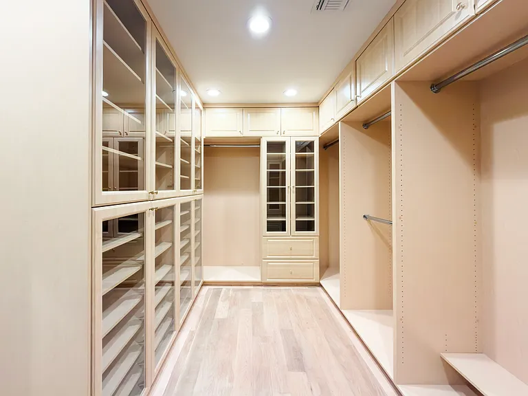 Custom walk-in closet with extensive built-in shelving offers premier storage in this Beverly Hills luxury rental home at 1094 Garden Lane, ideal for an executive rental.