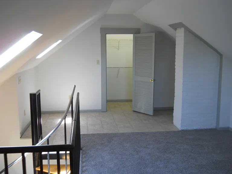 North half of Masterbedroom and large walk-in Closet. Features crank out skylight window on left.