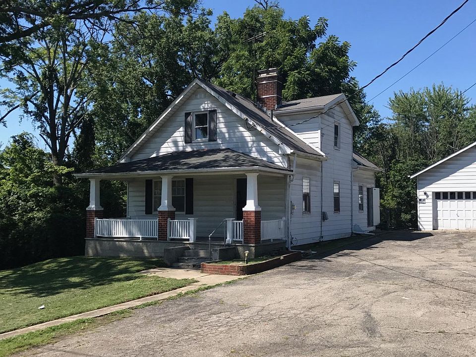 front view of house and 2 car detached garage w/3 floors on