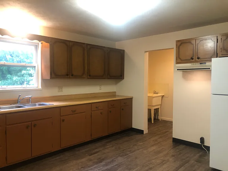 Kitchen with a view of the first floor laundry hookups.