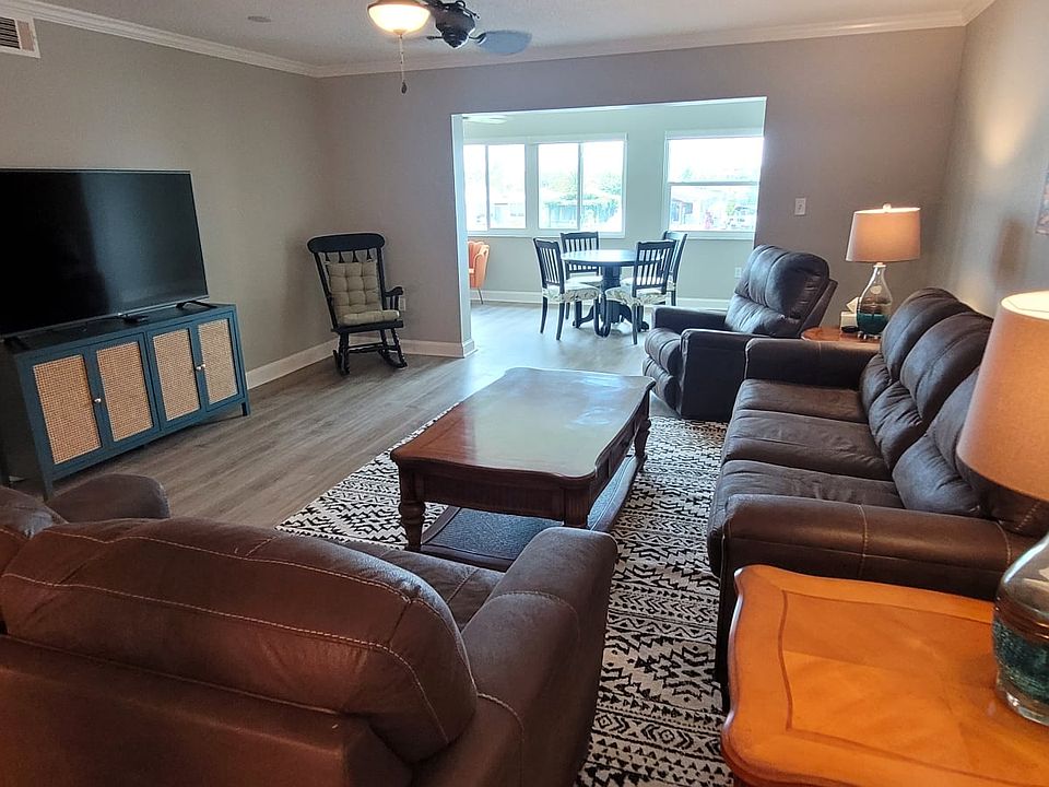Great room with brand new sofa, love seat and matching recliner. Includes 65" TV with full cable and internet connection. Waterfront views are accessible throughout this room and the sunroom on the other side.