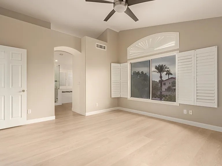 Masrter Bedroom with Large Windows Overlooking the Backyard .