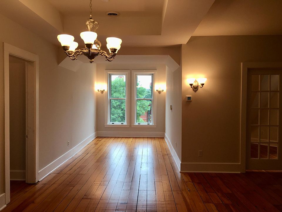 View of dining/living room looking out to Summit Avenue. Bedroom 2 to the left and Bonus room through the French doors