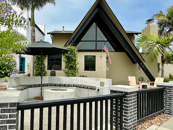 Fenced patio and yard with built in firepit and seating!