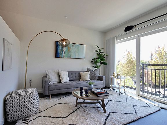 CREW Apartments Apartment Home Living Room with Balcony View