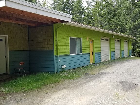 The white door enters a storage area, the Yellow door leads to the designated living area.