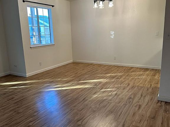 Dining room with new bright light fixture with iron curtain rod