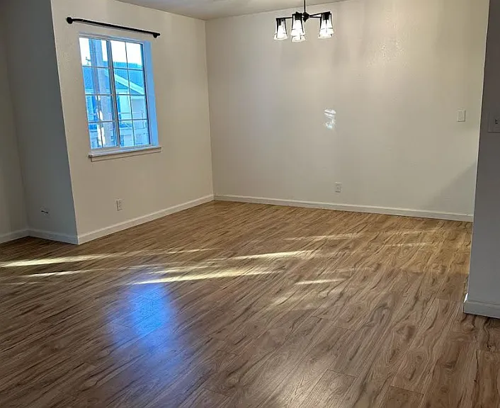 Dining room with new bright light fixture with iron curtain rod