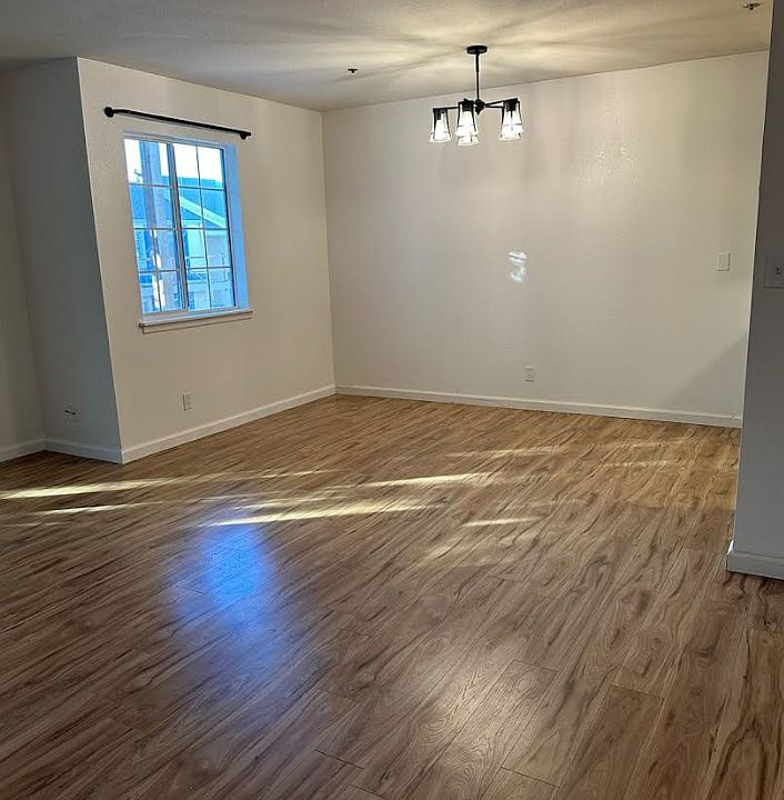 Dining room with new bright light fixture with iron curtain rod