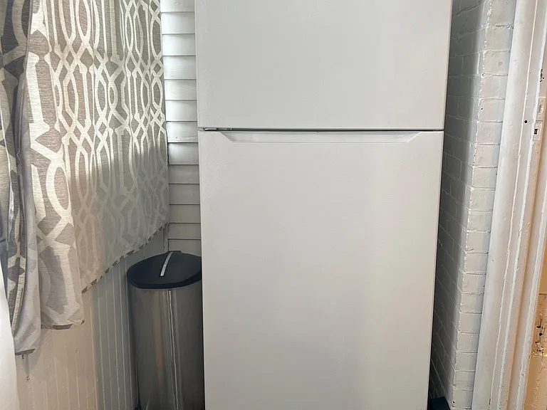Fridge in room next to the kitchen to give more space.