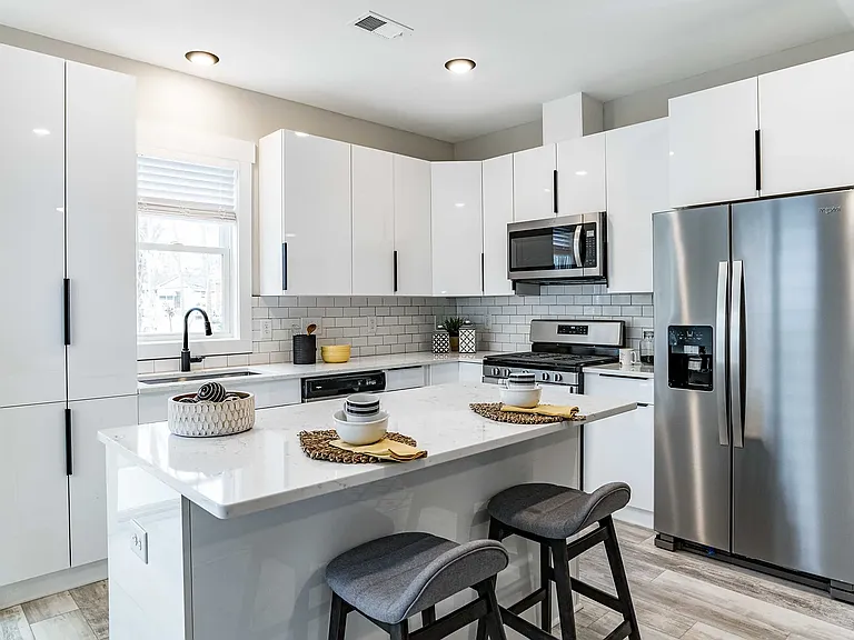 Lots of cabinets in this chef's kitchen with tile backsplash, all new SS gas stove, microwave, dishwasher and refrigerator.