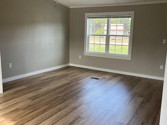 Living Room: Large open floor plan with vaulted ceiling