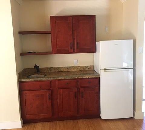 Granite counter tops and hardwood cabinets.