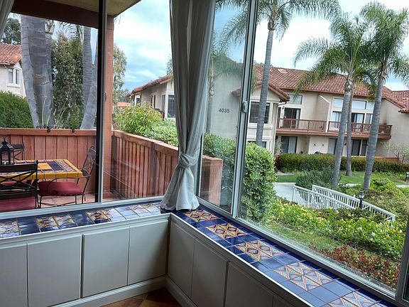 View of patio and lake footbridge from living room