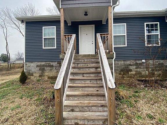 Building is located at the back of the property. The duplex is on the right and Apt. A is on the right.