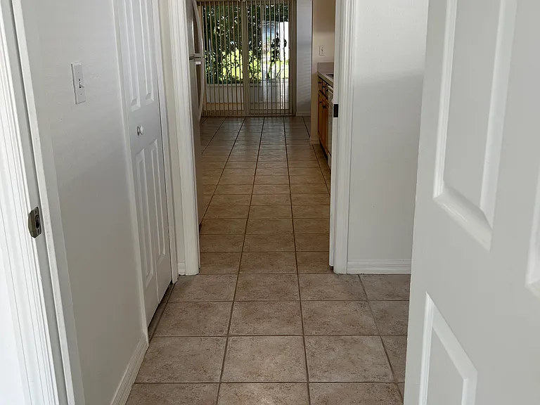 Entrance from garage to laundry room, kitchen, nook and double door to patio to back yard