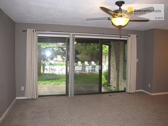 Sliders open to patio, which overlooks pool