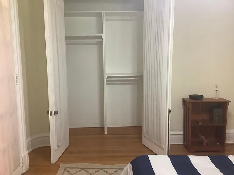 First bedroom showing closet with multiple storage options