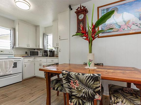 Dining area and kitchen area. (Stove in photo is replaced with brand new stainless steel range.)
