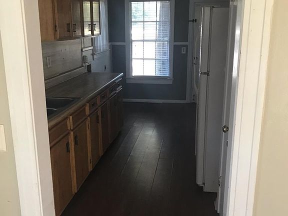 Kitchen from living room view. Fridge & stove stay with the house