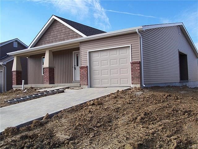 Large front porch with Craftsman style columns.  Enclosed patio on side of home.
