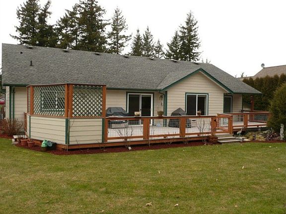 Photo of the back of the home. New decking provides ample space for entertaining. Natural gas plumbe