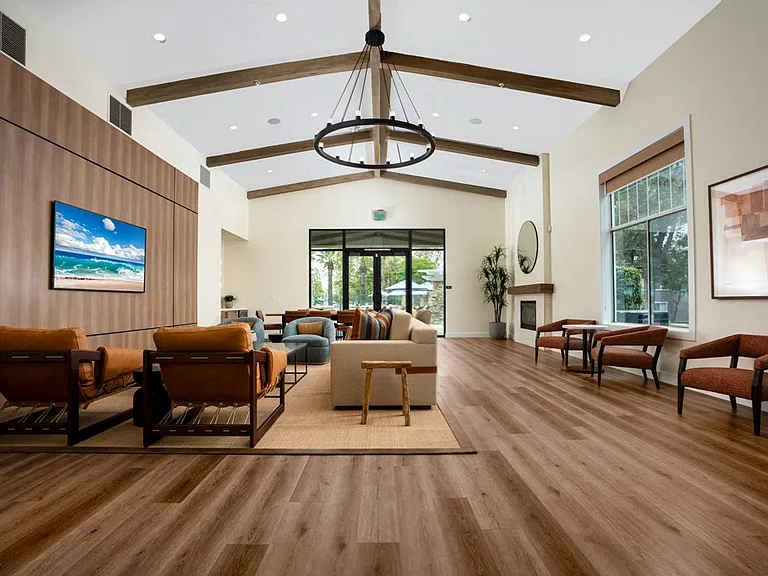 Resident Lounge with Comfortable Seating, Vaulted Ceilings, and Fireplace