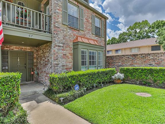 Notice the well-manicured landscaping and thoughtful details such as the decorative shutters and copper roof over the windows