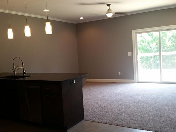 Living room with remote control ceiling fan, sliding glass d